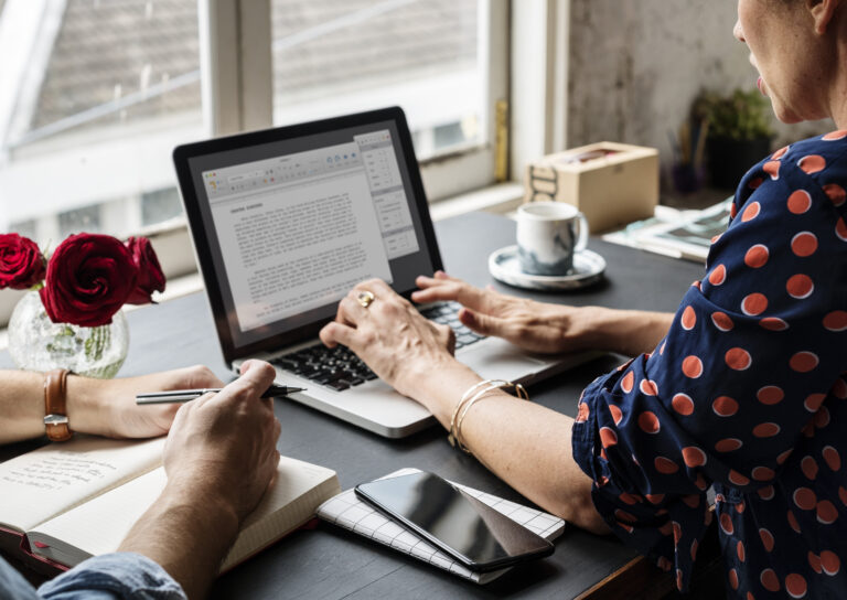 woman working on laptop typing essay information