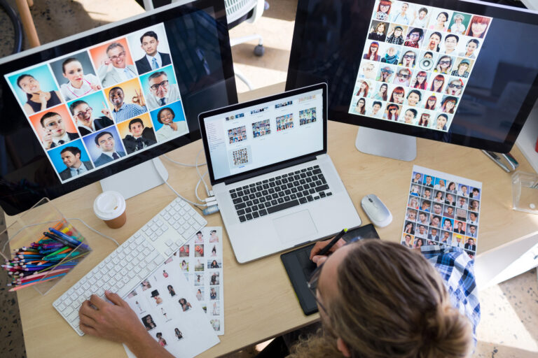 male executive working over laptop and graphic tablet at his desk